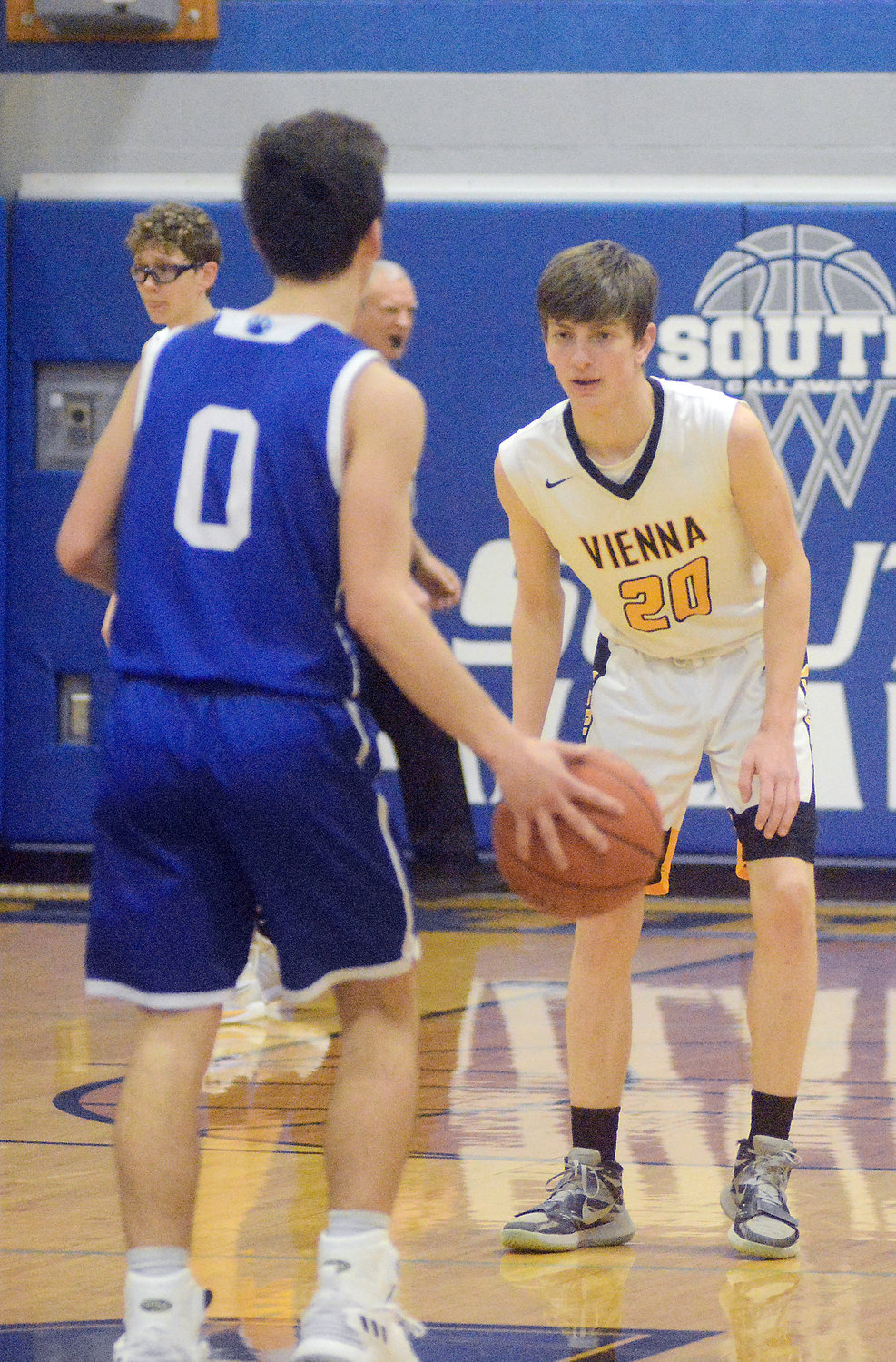 Cash Stricklan (far right) stares down Hermann’s Connor Coffey while playing defense for Vienna’s Eagles during their 58-48 victory Friday night in the championship game of the South Callaway Boys Basketball Tournament. The game was moved up to Friday instead of Saturday as originally scheduled to beat winter weather that hit the area early Saturday morning.